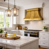 Riveted tin bell canopy range hood in transitional classic kitchen with window, Shaker cabinets, stone counter