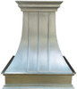 Natural zinc range hood with curved body and crown molding blending traditional proportion with modern craftsmanship