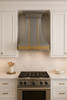 Custom zinc and brass metal range hood 36 inch in traditional kitchen, smooth zinc panels with brass apron above range and detailed cabinetry