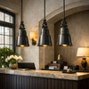 French inspired bell pendant lamps above boutique hotel front desk with paneled walls and warm brass tones