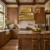 Gold brass range hood with polished rivets in an Early American kitchen with warm wood and stone counters