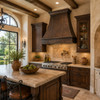 Antique copper bell range hood in bright Tuscan kitchen with walnut cabinetry, travertine and arched windows