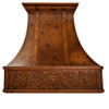 Handcrafted copper range hood with decorative lion motif apron