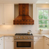 Rustic copper kitchen range hood with industrial look and rivets 30-inch in a traditional kitchen