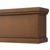 Close-up of hammered copper range hood apron with layered molding and finished side return