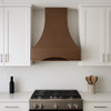 Strapless bell copper hood in a modern white kitchen with clean cabinetry and restrained design
