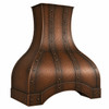 Angled view of hammered copper range hood with coffee patina, riveted straps, detailing curved dome canopy and arched apron