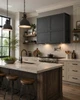 Industrial style rectangular black zinc range hood in transitional kitchen with refined cabinetry and stone counters