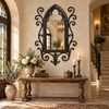 Gothic wrought iron mirror with quatrefoil tracery featured in an old world style foyer
