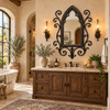 Gothic wrought iron mirror with quatrefoil tracery above a classic bathroom vanity