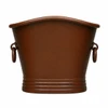 Mexican copper bathtub with rings from the end, showing the gently raised center rim and tapered profile