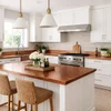 Warm transitional kitchen with a handcrafted hammered copper kitchen countertop and with a backsplash
