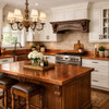 Old-world style ktichen with a handcrafted hammered copper kitchen countertop with a backsplash