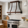 Transitional style kitchen designed with simple tile backsplashes and a wall mount mixed metal range hood