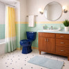 Mid-century retro pastel bathroom with the dark blue toilet as the statement piece