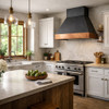Zinc range hood with hammered copper apron in a transitional kitchen blending modern lines with natural rustic artisan materials