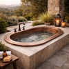 Drop-in oval copper bathtub with wide flat flange set into outdoor deck surround with open sky backdrop