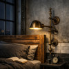 Industrial brass wall lamp with articulated arm and dome shade beside bed as reading sconce, focused downlight with bold mechanical attitude