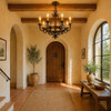 Mediterranean entry hall with arched window and Wrought Iron Ring Ceiling Chandelier hanging beneath dark ceiling beams