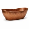 Hammered copper bathtub oval shape shown in angled side view with warm textured surface