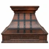 Front view of hammered copper range hood with darkened copper straps, tapered body and projecting crown molding