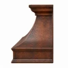 Side view of hammered copper range hood with sloped profile, projecting crown molding and darkened copper straps