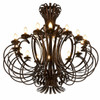 Sculptural iron chandelier with layered loop scrollwork, light on and artisan forged metal details on white backgroun