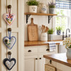 Artisan Cottage Heart Decorations hanging from farmhouse kitchen cabinet knobs beside open shelves