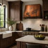 Sloped under-cabinet copper range hood with riveted band in an elegant walnut cabinetry kitchen with bright walls, large window, and stone countertops