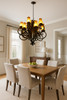 French style forged iron chandelier above table of a dining room