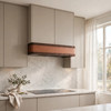 Warm transitional kitchen with hammered copper under cabinet hood and marble backsplash