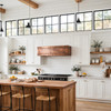 Hammered copper under-cabinet hood in a warm transitional kitchen with white cabinets and quartz