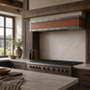 Hammered copper under-cabinet hood with aged zinc bands in an Alpine chalet kitchen