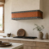 Hammered copper under-cabinet range hood with aged zinc bands in a Wabi-sabi kitchen