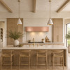 Hand-polished hammered under-cabinet copper range hood in a warm minimalist kitchen with flat-panel oak cabinetry and quartzite