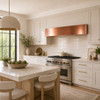 Hand-polished box-shaped under-cabinet copper range hood in a Soft Contemporary kitchen with warm neutral finishes
