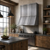 Riveted zinc panel range hood in industrial loft kitchen