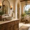 Mediterranean bathroom with oval cantera stone vessel sink, travertine surfaces, walnut vanity, bronze fixtures and arched window