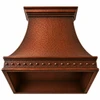 Underside of hand-hammered bell copper range hood with riveted apron showing hollow interior