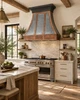 Zinc bell hood with smooth natural texture, copper framing in a modern rustic kitchen with plaster, reclaimed wood and natural stone