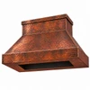 Underside of a hand-hammered copper range hood showing the rectangular opening for the range hood insert