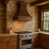 Rustic kitchen setup with a custom hammered copper hood