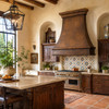 Spanish Colonial kitchen with dark hammered copper range hood, Talavera tile, carved wood cabinetry and Saltillo floor