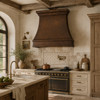 Rustic European kitchen with hammered copper range hood, limestone counters, reclaimed beams and inset cabinetry