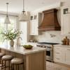 Transitional kitchen with hammered copper range hood, white cabinetry, quiet stone surfaces and contemporary appliances