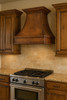 Country style kitchen copper vent hood in rustic kitchen, hammered copper canopy above wood beams and stone backsplash