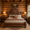 Mexican wooden headboard with hand carved sun and moon design in a cozy cabin bedroom