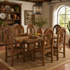Rustic Mexican wooden chair with arched back and slatted seat around a farmhouse table