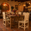 Rustic Mexican wooden chair with woven seat and scalloped back inside a Mexican cantina