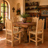 Rustic Mexican wooden chair with woven seat and scalloped back in a warm hacienda kitchen